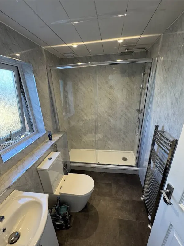 Fully refitted bathroom with sliding-door shower, new suite and chrome towel radiator