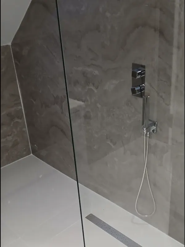 Walk-in shower with low-profile tray, linear drain and glass screen
