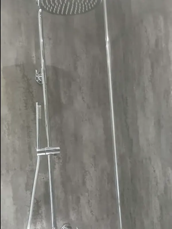 Chrome thermostatic shower column with rainfall head on concrete-effect wet-wall panels